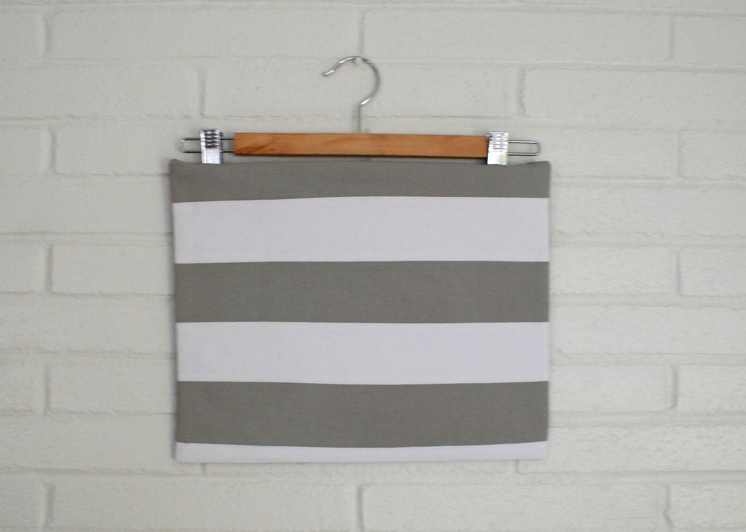 Grey and white striped zippered clutch.