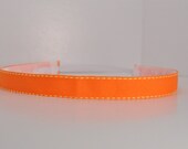 Band-It Headband.... Solid Orange with Yellow Stitch - Skinny.  Will stay put and not slip.