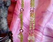 Green beaded dangle earrings with pink clear india beads.