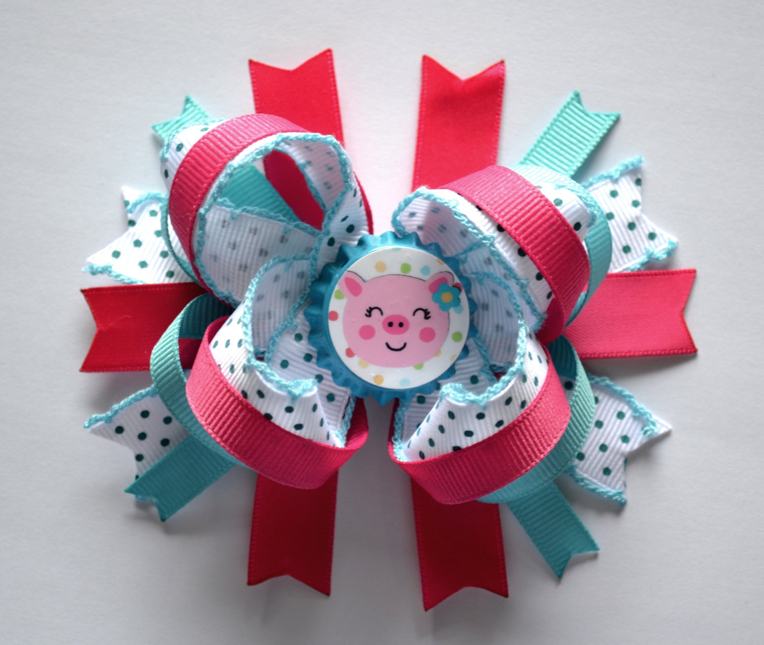 Cute pig bottlecap hair bow. Pink, blue, and white.