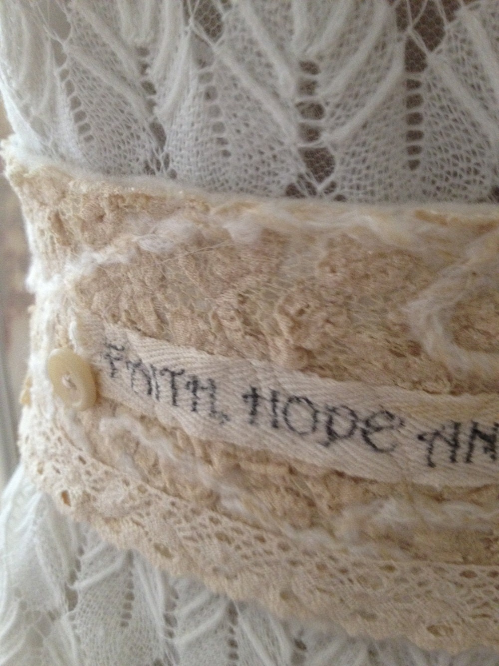 Lace and felt covered sash/belt adorned with buttons and beautiful yarns.