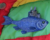 Fish with city growing on back.