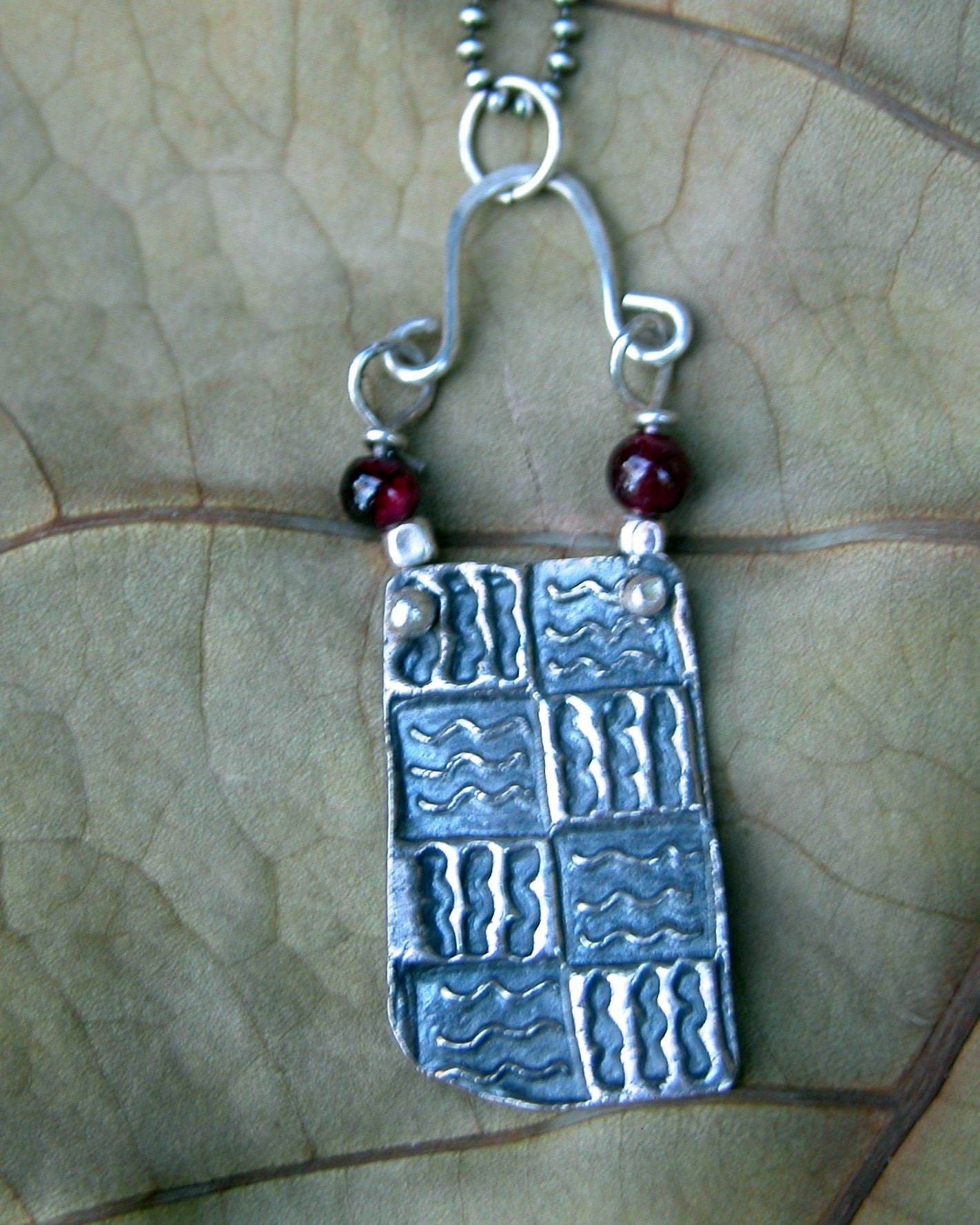 Quilted silver and garnets pendant