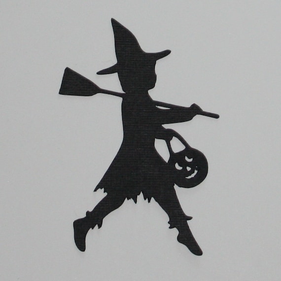 black silhouette halloween die cut child trick or treating in a witch costume