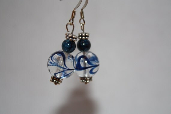 Clear glassworks beads with swirling navy blue throughout