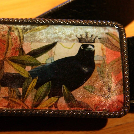 crow with a crown belt buckle