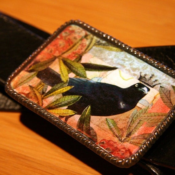 crow with a crown belt buckle