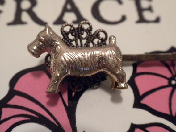 Bobby pin in the shape of a scottie-breed dog