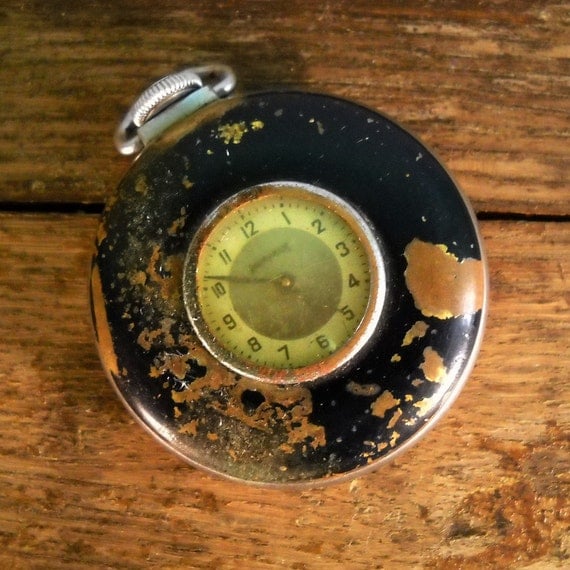 Image of worn and antiqued pocket watch