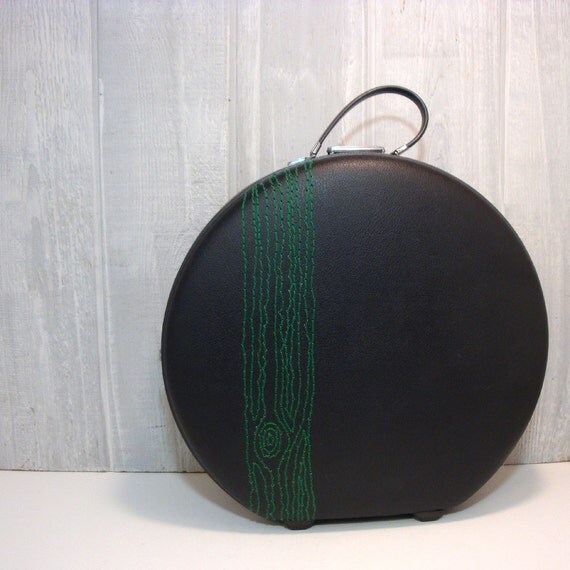 round suitcase with embroidery