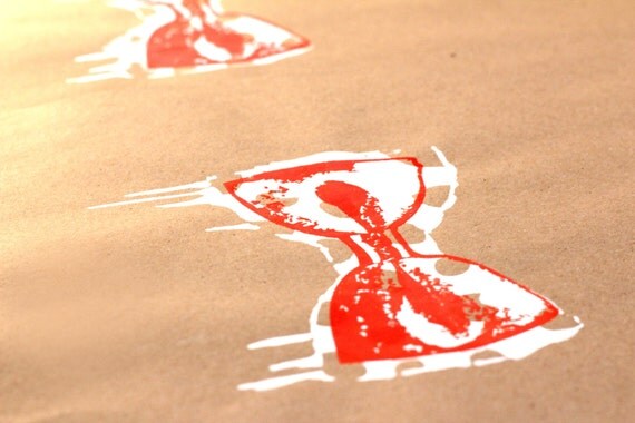 Minimal screenprint. Red and white drippy polka dot bow tie on Kraft paper. 11 x 17.