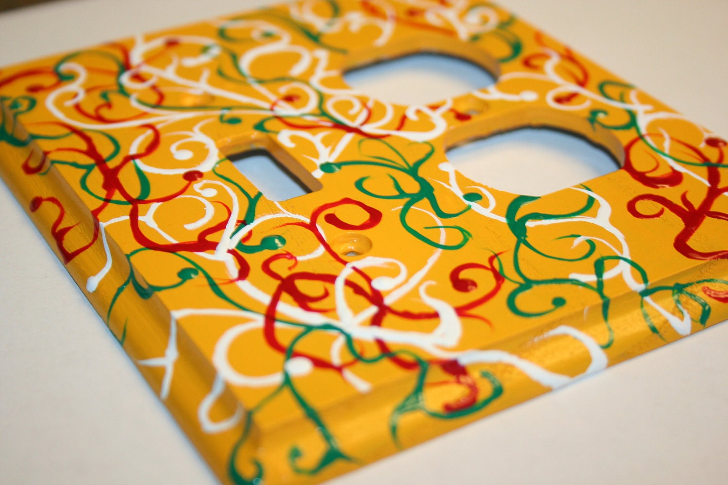 Hand Painted Toggle Duplex Outlet Cover Plate- Yellow with Red, White and Green Swirls