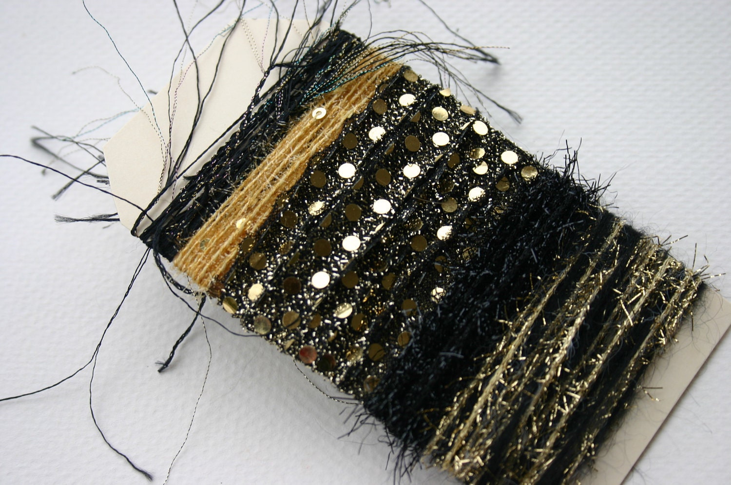 Elegant gold and black metallic specialty yarn fiber embellishent bundle