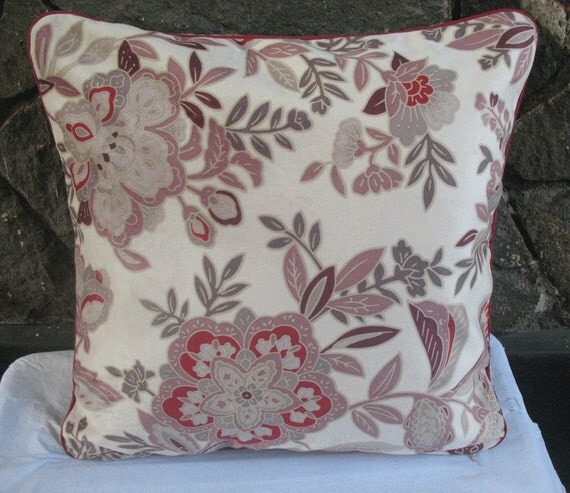 cream throw pillow with floral design