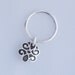 Sterling silver charm ring with floral shaped charm