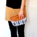 Clutch purse with leather flap and detachable strap
