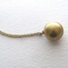 Brass ball locket necklace on long antiqued gold metal chain, upcycled vintage jewelry
