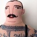 Tattooed man with mustache doll
