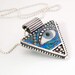 Silver Triangle Pendant with Eye inlaid with Blue Green Iridescent Mosaic Polymer