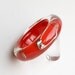 Red lucite bracelet with safety pins