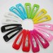 20 pcs of 60 mm. Snap clip with assorted colors plastic cover