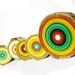 eclectic collection of contemporary paintings on repurposed sliced tree trunks by tracy melton