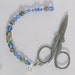 Scissor Fob - Blue Czech Crystal Faceted Beads, Green Cloisonne Beads - with blue pink and white flowers - 6 1/4 inches long