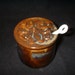 jar with magnolia flower and spoon in browns