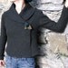 wrap sweater, cardigan, jacket made in extra soft and elastic boiled wool in dark olive green with rose brooch