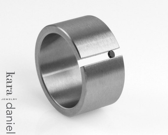 black diamond tension set in stainless steel . ring