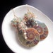 Ammonite Fossil Earrings with Sapphires, Andalusite, Zircon, and Smoky Quartz