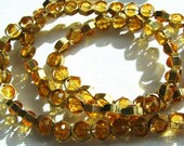 From the Hive.  Honey coloured Czech fire polished beads in brass honeycomb beads. Necklace