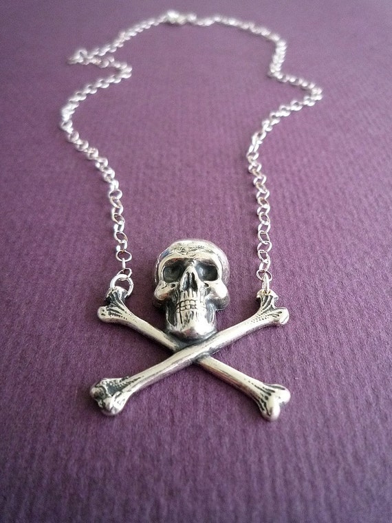 Items similar to skull and crossbones necklace in silver on Etsy