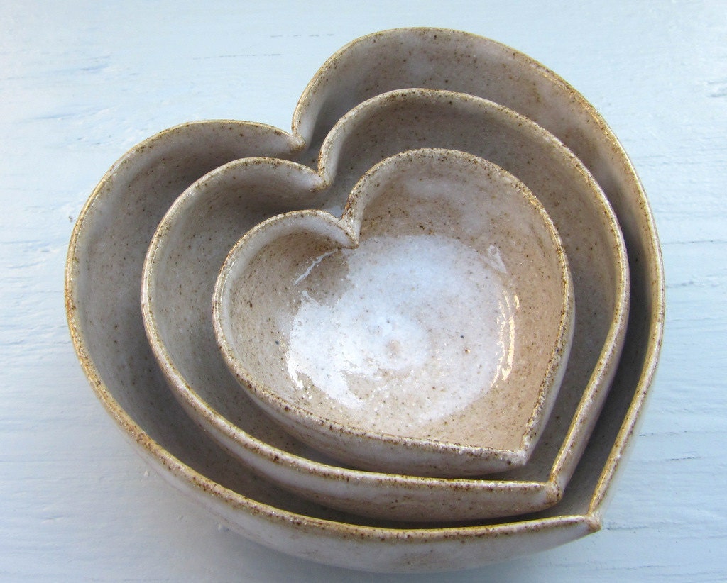 3 nesting white heart bowls filled with love in rustic