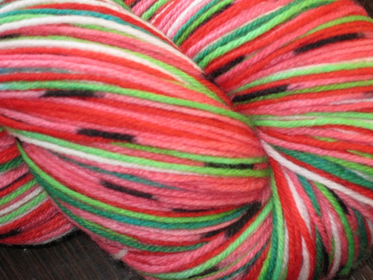 Hand dyed self striping watermelon sock yarn with seeds