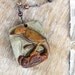carved bird pendant necklace succor creek jasper, fresh water pearls, and garnet sterling silver dark metal
