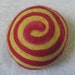 One multi-colored felted pin-cushion, Red and Yellow