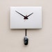 Clock created from a recycled Apple Powerbook laptop cover