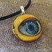 Googly eye, a wooden charm pendant