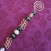 hammered copper candle snuffer with green glass beads