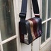 Seat belt bag made from reclaimed seatbelts.