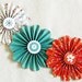 paper flowers garland orange turquoise wedding wall decor photo shoot