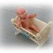 VINTAGE TINY RUBBER BABY DOLL with PLASTIC CRADLE