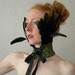 Verdigris stained Leather and Jet-Black Feather Ruff.