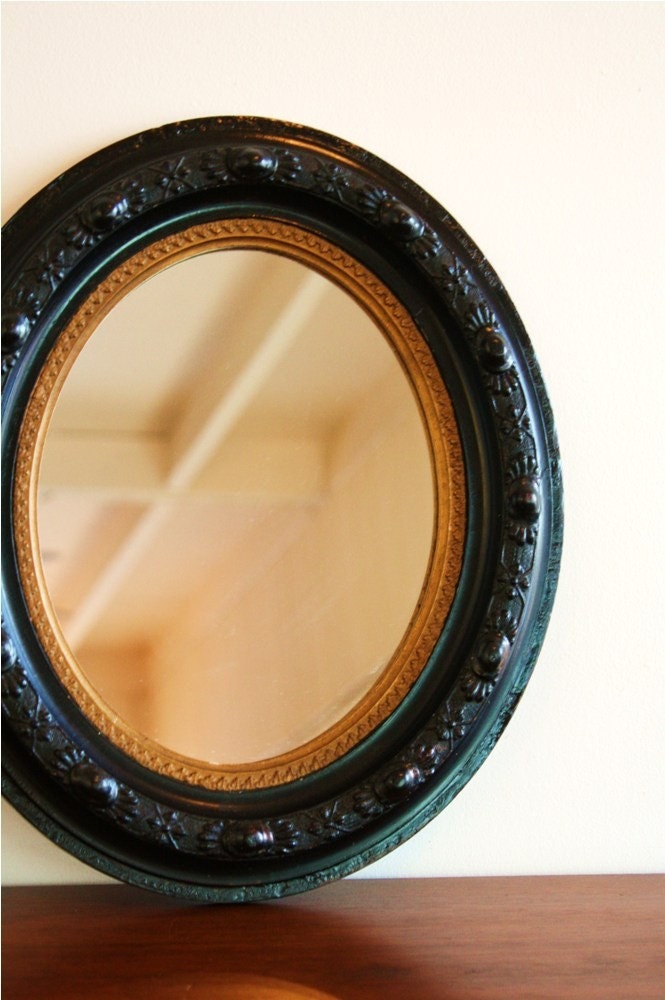 Vintage round mirror with dark wood frame and gold trim