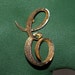 E Initial pin Mamselle Greenbert designer goldtone brooch pin