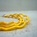 Yellow curled thread wrapped necklace