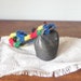 Vintage metal cow bell with leather strap surrounded by colorful yarn square nail as clapper