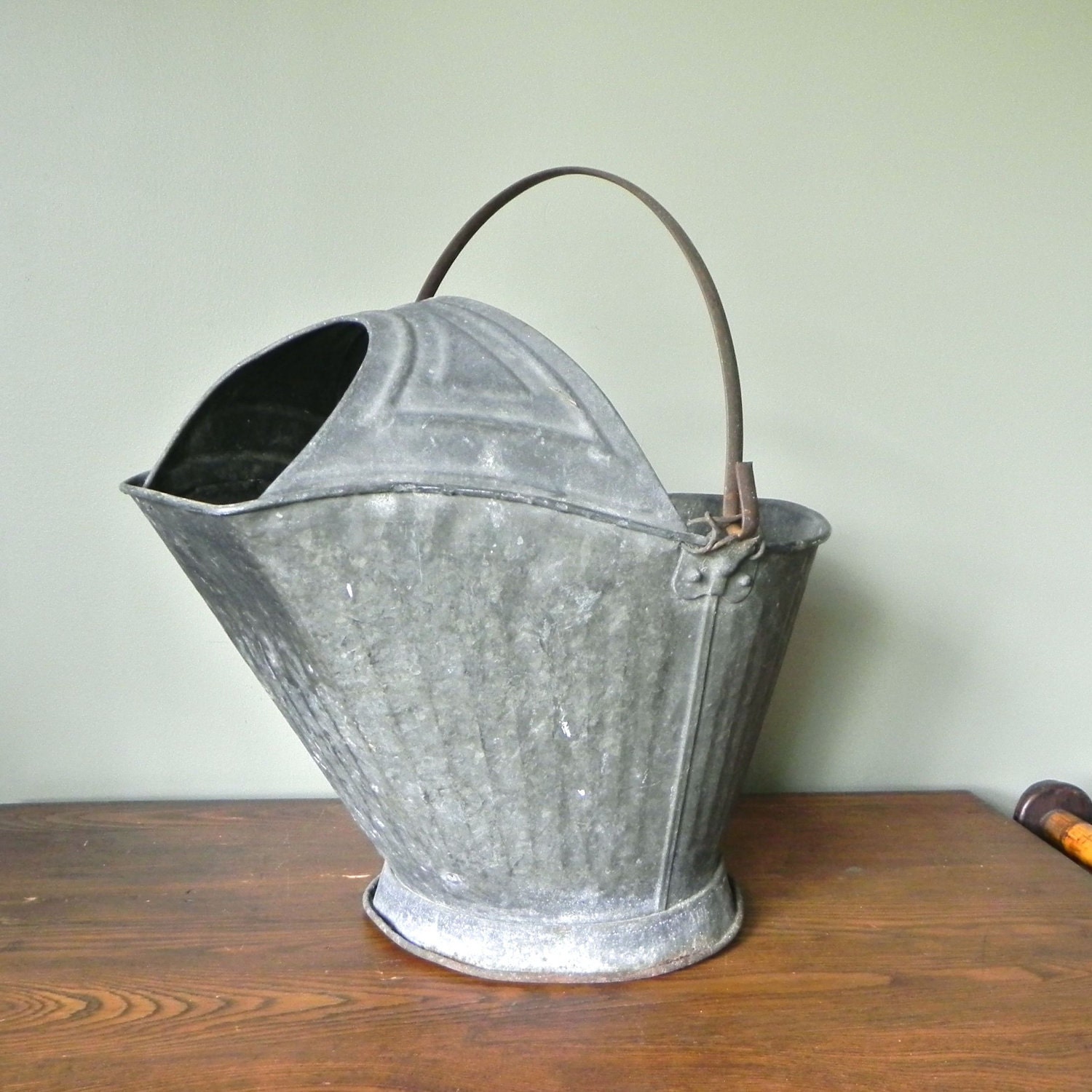 Vintage galvanized metal coal scuttle use as log carrier