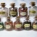 Bottles: Box of 9 small glass bottles of various chips with a natural cork